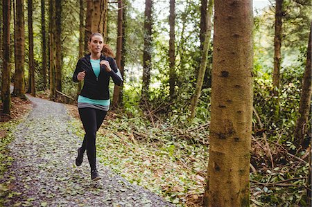 simsearch:6109-08435603,k - Fit brunette make a run in the woods Stock Photo - Premium Royalty-Free, Code: 6109-08435607