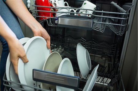 dishwasher - Pretty blonde woman emptying the dishwasher in the kitchen Stock Photo - Premium Royalty-Free, Code: 6109-08435705