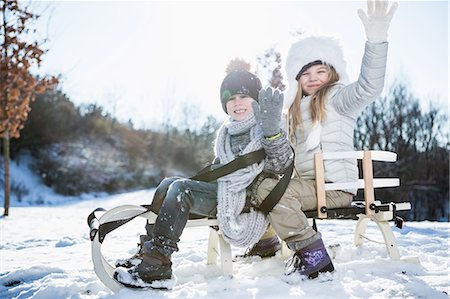 simsearch:6109-08435908,k - Brother and sister playing with sled on a beautiful snowy day Stock Photo - Premium Royalty-Free, Code: 6109-08435857