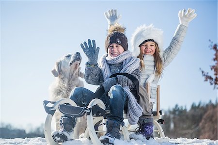 dogs of sleds - Brother and sister playing with sled on a beautiful snowy day Stock Photo - Premium Royalty-Free, Code: 6109-08435855