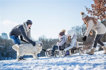 streicheln - Father and children playing with sled on a beautiful snowy day Stockbilder - Premium RF Lizenzfrei, Bildnummer: 6109-08435860