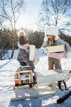 simsearch:6109-08435850,k - Brother and sister taking presents on a beautiful snowy day Stock Photo - Premium Royalty-Free, Code: 6109-08435901
