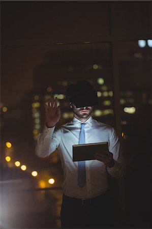 Businessman using technology at night Stock Photo - Premium Royalty-Free, Code: 6109-08581433