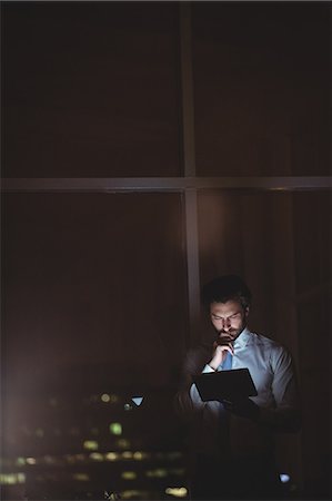 simsearch:6109-08581416,k - Businessman using tablet at night Stock Photo - Premium Royalty-Free, Code: 6109-08581431