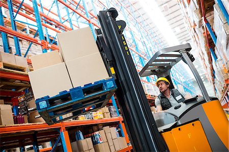 distribution warehouse - Warehouse worker using forklift Stock Photo - Premium Royalty-Free, Code: 6109-08581567