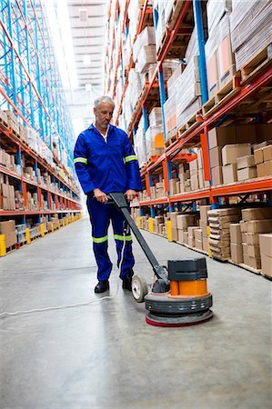 Man cleaning warehouse floor with machine Fotografie stock - Premium Royalty-Free, Codice: 6109-08581692