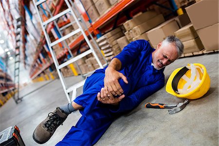 Worker lying and suffering on the floor Stock Photo - Premium Royalty-Free, Code: 6109-08581601