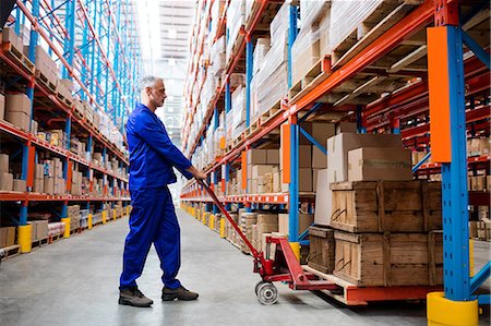 shipping warehouse - Man worker using pallet truck Stock Photo - Premium Royalty-Free, Code: 6109-08581607