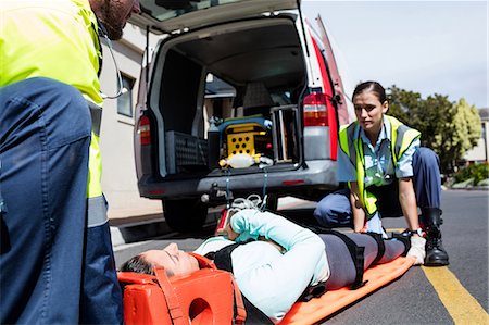 first medical assistance - Ambulance men taking care of injured people Stock Photo - Premium Royalty-Free, Code: 6109-08581760