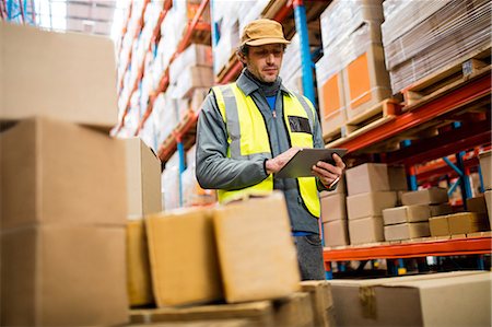 shipping warehouse - Worker using digital tablet Stock Photo - Premium Royalty-Free, Code: 6109-08581704