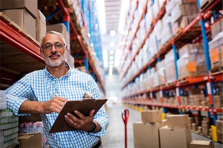 delivery business - Man posing with his clipboard Stock Photo - Premium Royalty-Free, Code: 6109-08581712