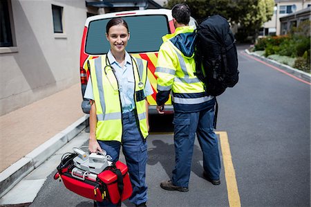 simsearch:6109-08689784,k - Ambulance men carrying care facilities Photographie de stock - Premium Libres de Droits, Code: 6109-08581736