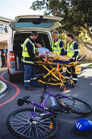 simsearch:6109-08581734,k - Injured man assisted by ambulance men Stock Photo - Premium Royalty-Free, Code: 6109-08581873