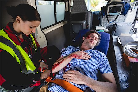 simsearch:6109-08581880,k - Injured man with ambulancewoman Photographie de stock - Premium Libres de Droits, Code: 6109-08581827