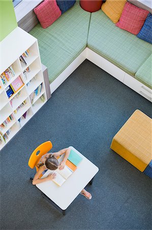 simsearch:6109-07497515,k - School girl reading a book in library Photographie de stock - Premium Libres de Droits, Code: 6109-08581941