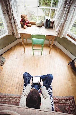 floor cushion - Overhead of hipster man using tablet computer Stock Photo - Premium Royalty-Free, Code: 6109-08581981