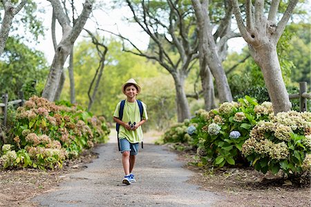 picture of boy planting tree - Little boy walking on path Stock Photo - Premium Royalty-Free, Code: 6109-08581924