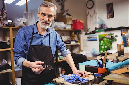 Cobbler posing without his glasses Stock Photo - Premium Royalty-Free, Code: 6109-08582149