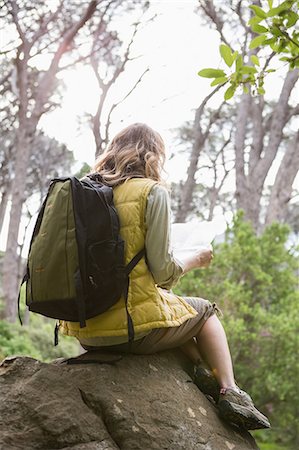 people on trail with map - Woman sitting on a stone Stock Photo - Premium Royalty-Free, Code: 6109-08536397