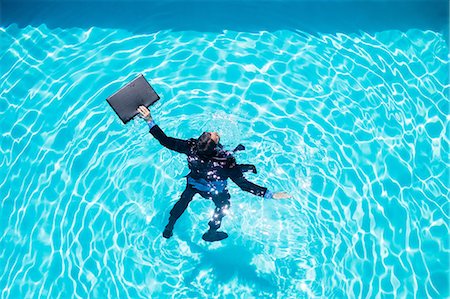 string bag - Dressed businessman in swimming pool Stock Photo - Premium Royalty-Free, Code: 6109-08536449