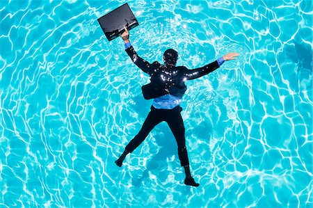 string bag - Dressed businessman in swimming pool Stock Photo - Premium Royalty-Free, Code: 6109-08536450