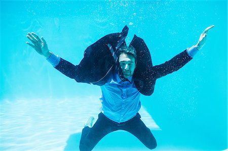 sunlight underwater - Dressed businessman in swimming pool Stock Photo - Premium Royalty-Free, Code: 6109-08536456