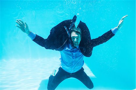 diving in the swimming pool - Dressed businessman in swimming pool Stock Photo - Premium Royalty-Free, Code: 6109-08536456