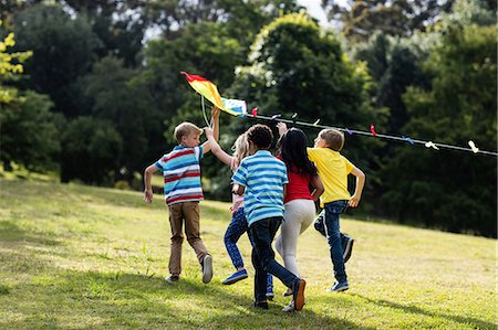 flying kites - Children playing with a kite Stock Photo - Premium Royalty-Free, Code: 6109-08536433