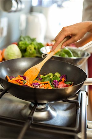 stove element - Cropped image of woman cooking food Foto de stock - Sin royalties Premium, Código: 6109-08536689