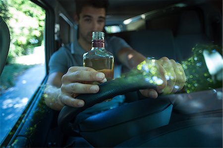 reflection on windshield - Drunk man drinking alcohol bottle Stock Photo - Premium Royalty-Free, Code: 6109-08536697