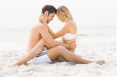 embrace couple swim suit - Happy couple sitting and embracing Stock Photo - Premium Royalty-Free, Code: 6109-08536764