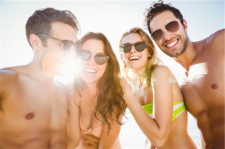 simsearch:6109-08536794,k - Portrait of smiling friends on the beach Stock Photo - Premium Royalty-Free, Code: 6109-08536797