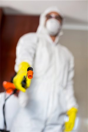 simsearch:6109-08537565,k - Low angle view of worker holding sprayer Stock Photo - Premium Royalty-Free, Code: 6109-08536706