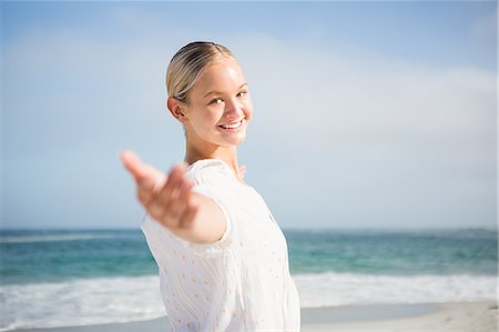 simsearch:6109-07496983,k - Pretty blonde woman outstretching her arms Stock Photo - Premium Royalty-Free, Code: 6109-08536887