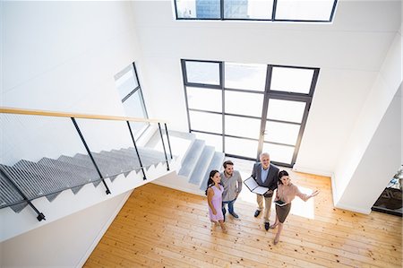 people in apartment - Real estate agent showing new house to couple Stock Photo - Premium Royalty-Free, Code: 6109-08537137