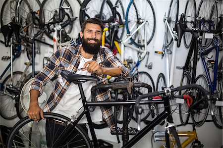 simsearch:6109-08537278,k - Bike mechanic checking at bicycle Stock Photo - Premium Royalty-Free, Code: 6109-08537268