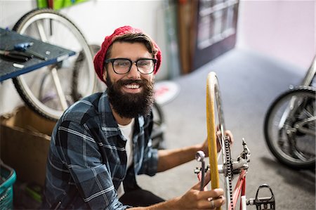 Bike mechanic checking at bicycle Stock Photo - Premium Royalty-Free, Code: 6109-08537271