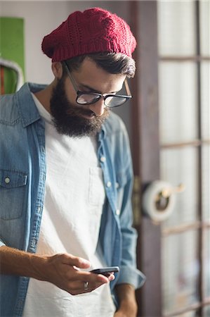 floor boards - Bike mechanic checking his phone Stock Photo - Premium Royalty-Free, Code: 6109-08537297