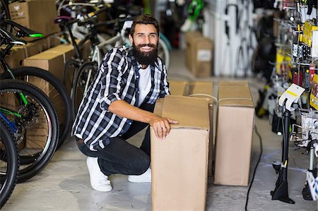 Casual hipster picking up box delivery Stock Photo - Premium Royalty-Free, Code: 6109-08537225