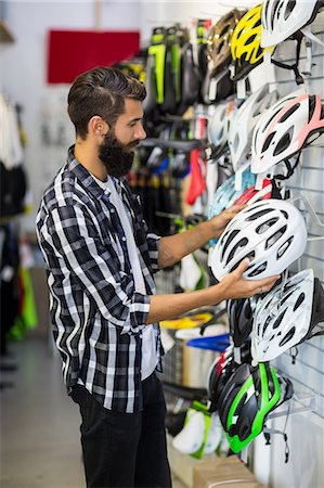 simsearch:6109-08537285,k - Hipster customer picking up a helmet Stockbilder - Premium RF Lizenzfrei, Bildnummer: 6109-08537231