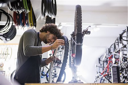 simsearch:6109-08537332,k - Worker repairing bicycles Stock Photo - Premium Royalty-Free, Code: 6109-08537357