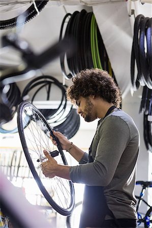 simsearch:6109-08537332,k - Worker repairing bicycles Stock Photo - Premium Royalty-Free, Code: 6109-08537355