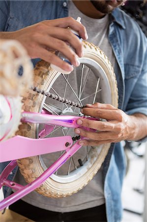 simsearch:6109-08537332,k - Worker repairing bicycles Stock Photo - Premium Royalty-Free, Code: 6109-08537380