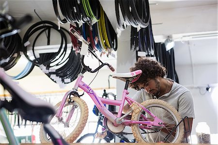 simsearch:6109-08537332,k - Worker repairing bicycles Stock Photo - Premium Royalty-Free, Code: 6109-08537382