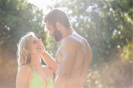 simsearch:6109-06195106,k - Happy couple in swimwear looking face to face Stock Photo - Premium Royalty-Free, Code: 6109-08537397