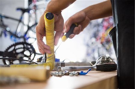 simsearch:6109-08537332,k - Close-up of worker repairing bicycles Stock Photo - Premium Royalty-Free, Code: 6109-08537314