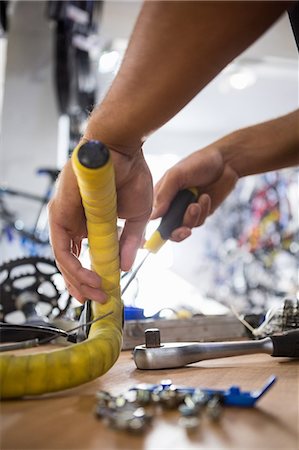 simsearch:6109-08537332,k - Close-up of worker repairing bicycles Stock Photo - Premium Royalty-Free, Code: 6109-08537315