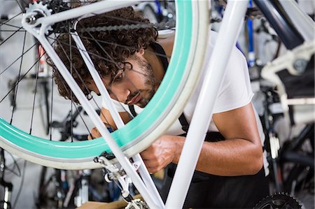 simsearch:6109-08537332,k - Worker repairing bicycles Stock Photo - Premium Royalty-Free, Code: 6109-08537319