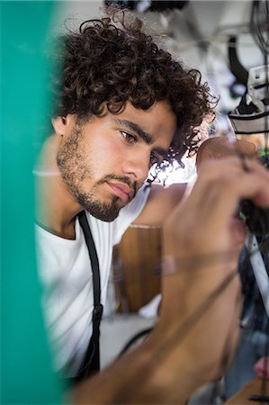 simsearch:6109-08537332,k - Worker repairing bicycles Stock Photo - Premium Royalty-Free, Code: 6109-08537324