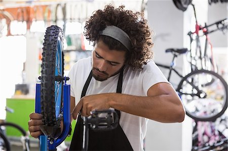 simsearch:6109-08537332,k - Worker repairing bicycles Stock Photo - Premium Royalty-Free, Code: 6109-08537334